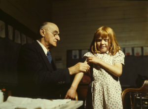 Dr. Schreiber of San Augustine giving a typhoid innoculation at a rural school