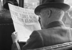 Reading war news aboard streetcar. San Francisco, California